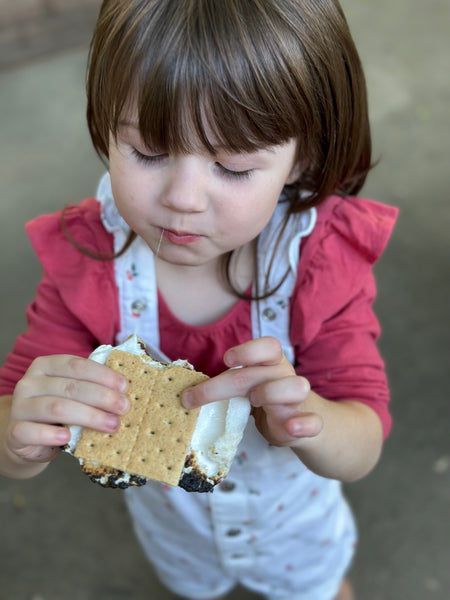 Little girl enjoying a freshly made s'more