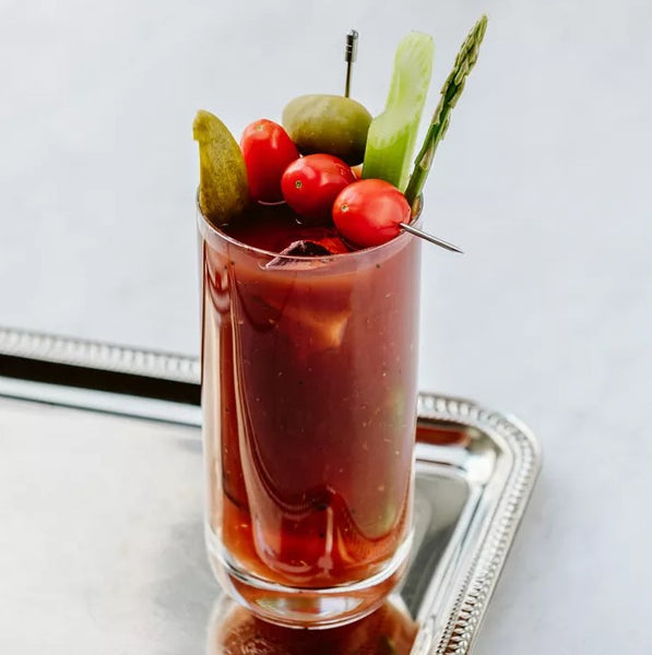 Bloody Bulldog cocktail with tomato, olive, pickle and other garnishes with a link to the recipe