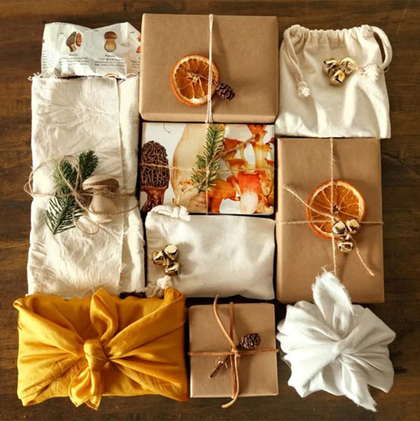 christmas presents wrapped with fabric and brown paper with link to more ideas for eco friendly wrapping