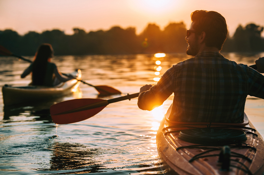People Kayaking during Sunset