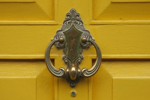 Door knocker on yellow door