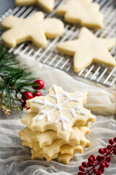 sugar cookies shaped like snowflakes with link to recipe