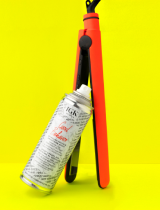 a spray can on a hair straightener