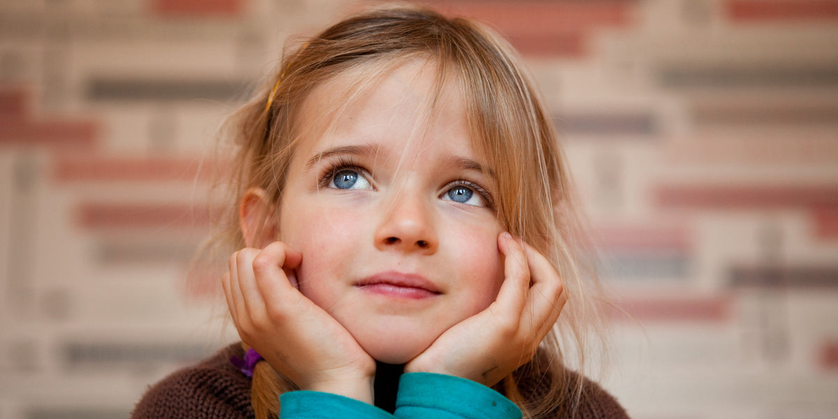 little girl with her hands on her chin