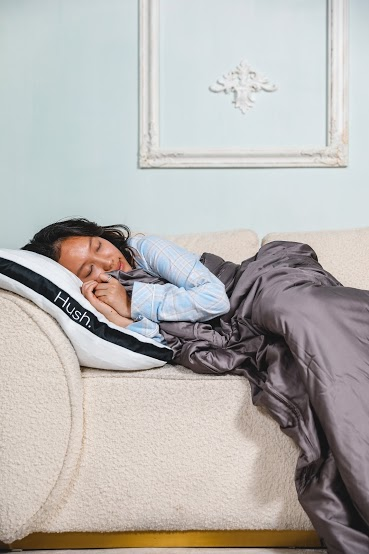 Woman sleeping on the couch with a weighted blanket