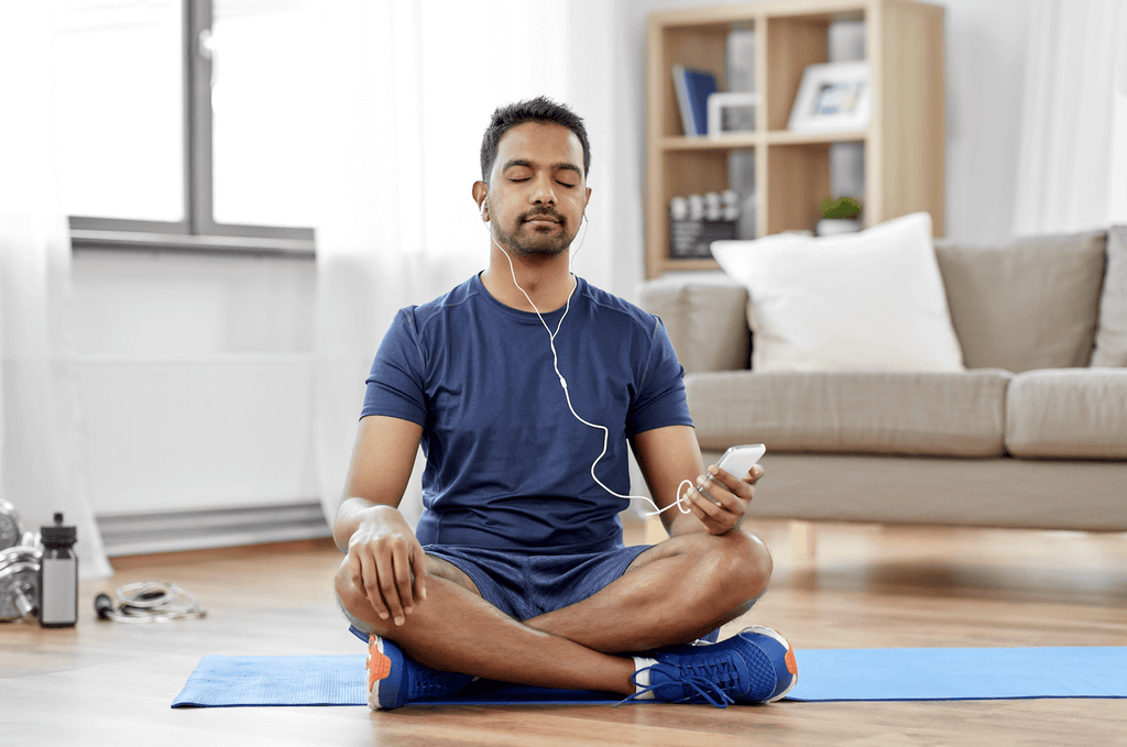 man meditating on the floor