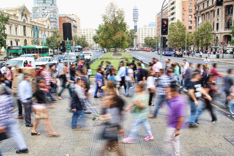landscape shot of a busy street filled with people crossing
