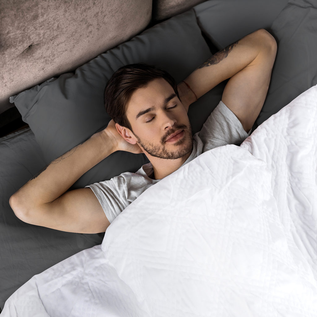 man sleeping beneath a weighted blanket