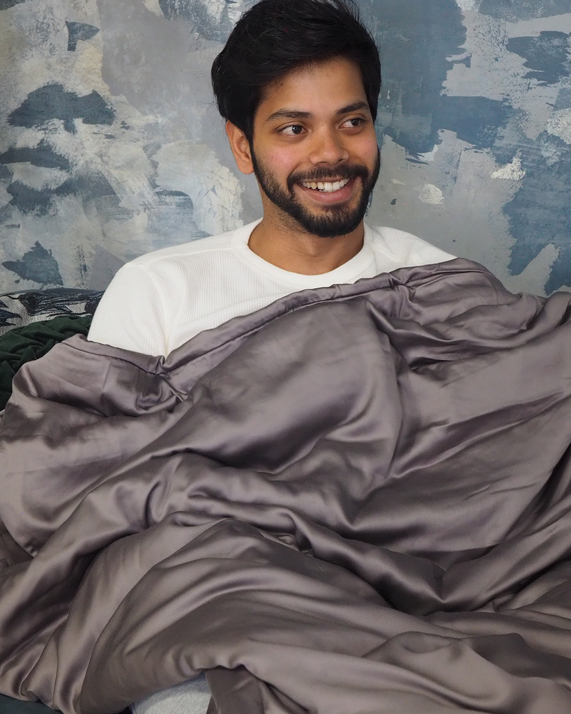 smiling man with a weighted blanket