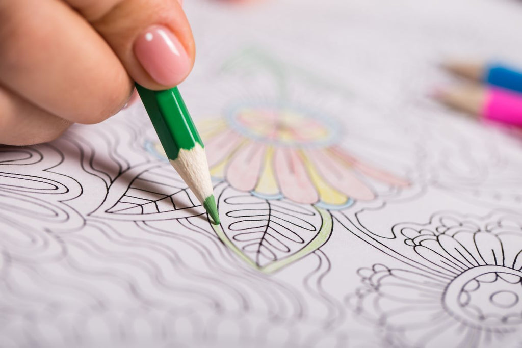 stress relief gifts: person using an adult coloring book