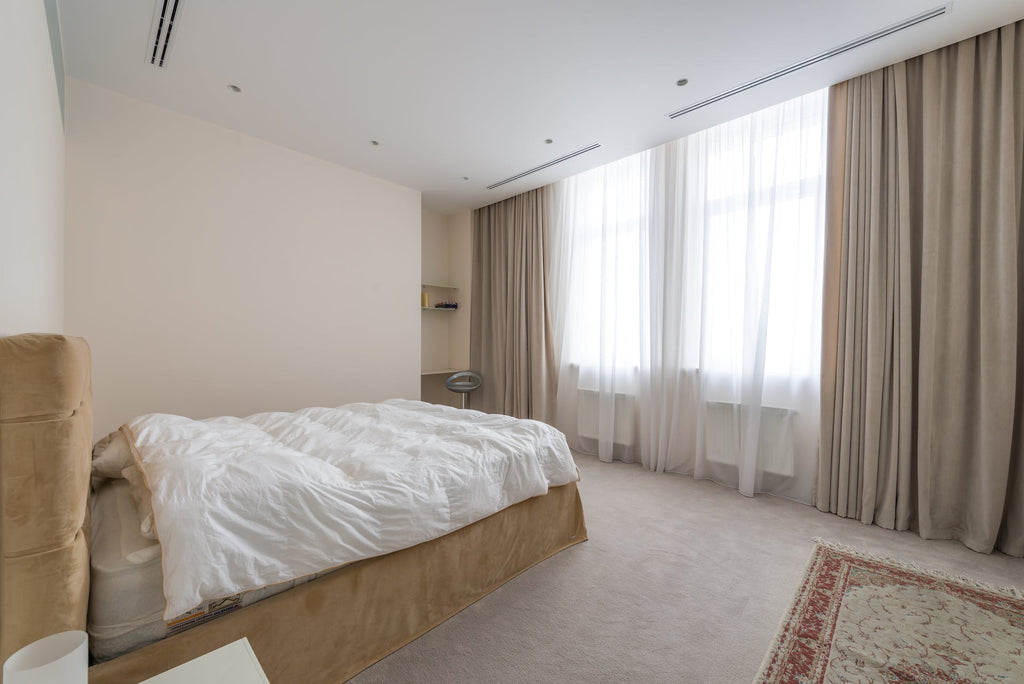 pastel colored bed covered in white duvet