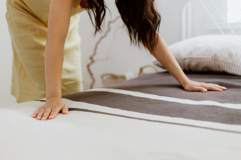 woman fixing a bed