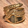 An adjustable, artisan handmade smooth pure brass, dotted and swirl patterned wrap ring designed by OMishka.