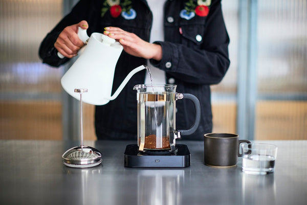 Pouring water onto coffee in a cafetiere