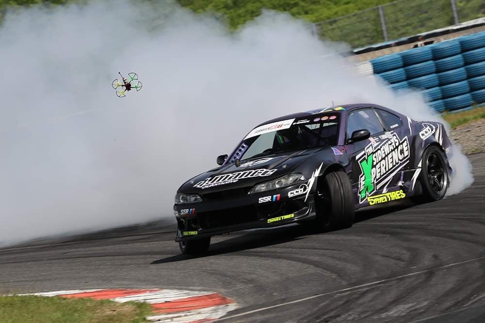 Formula Drift Nissan S15 with wheels turned out drifting.