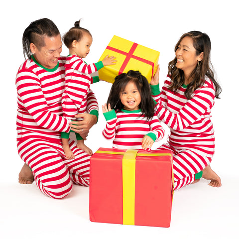 Family opening gifts in Mightly's Kids and Adult Holiday Pajamas