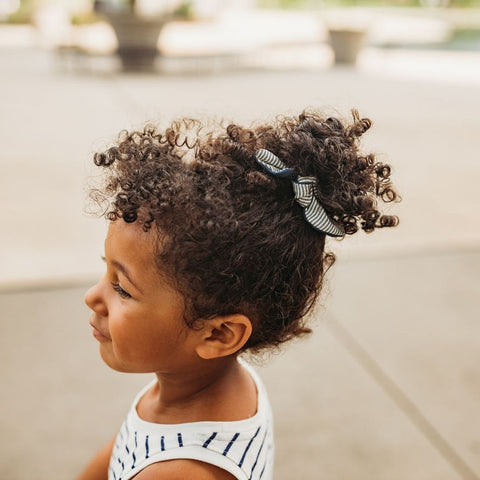 Girl wearing Jackalo's Bow scrunchie in her hair