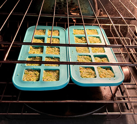 image of two souper cubes 2T trays in an oven baking broccoli cheddar tots