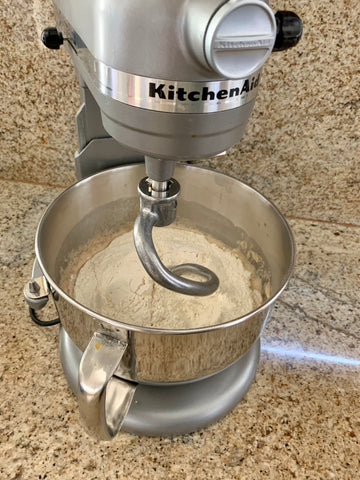 Using a dough hook attachment to mix challah dough