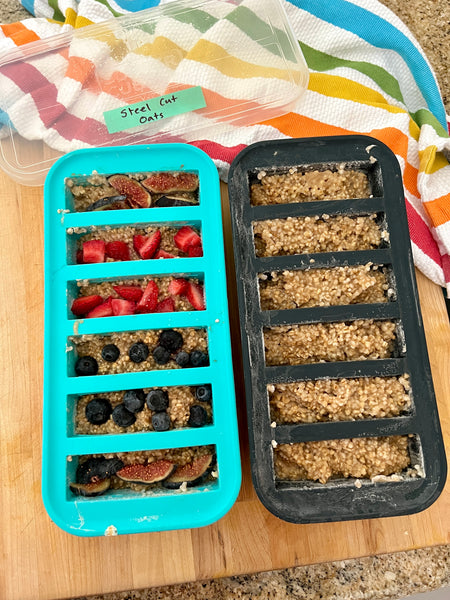steel cut oats frozen in two half-cup souper cubes trays. left tray has toppings and right tray is left plain