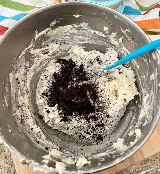 cream cheese filling in mixer bowl with cookie crumbs