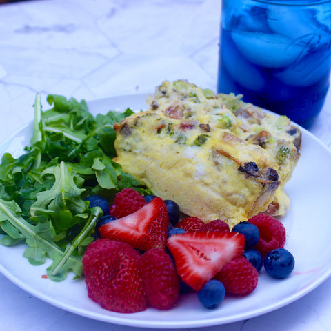 Cooked quiche (sliced) on plate with sides