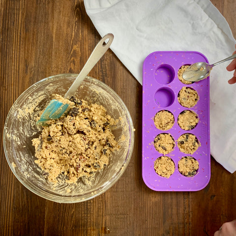 placing cookie dough in the cookie tray by souper cubes with a spoon