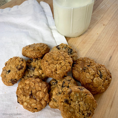 baked oatmeal cookies next to a cup of milk