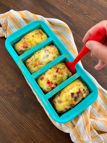 Using a silicone spatula to loosen baked quiche from the Souper Cubes mold