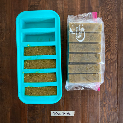 image of salsa verde in a half-cup souper cubes tray with 6 frozen half-cup portions in a ziploc bag to the side.