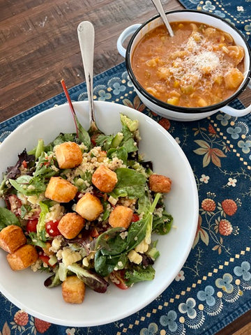 image of a bowl of soup next to a bowl of salad