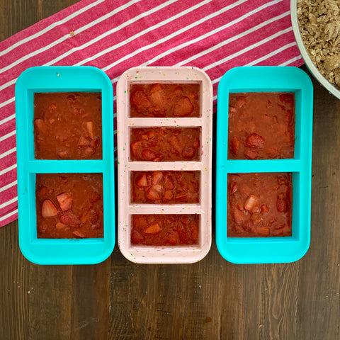 image of three souper cubes trays on a table with strawberry rhubarb filling in them