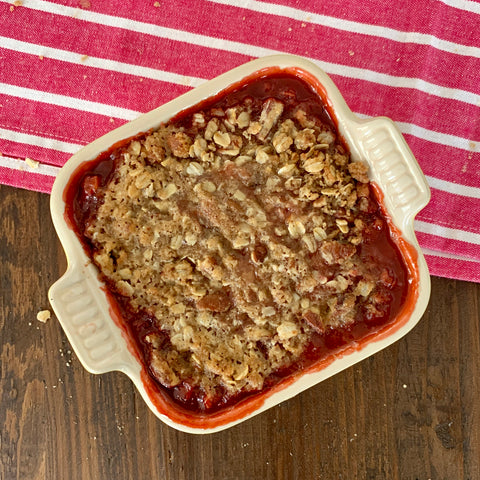 image of strawberry rhubarb crisp baked in a small dish