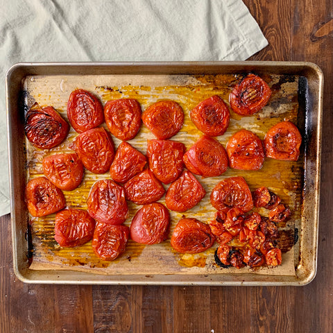 Sheet pan of oven-roasted roma tomatoes