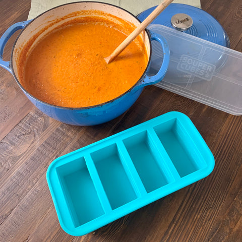 pot of creamy basil tomato soup with a 1cup souper cubes tray next to it