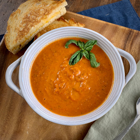bowl of creamy basil tomato soup with grilled cheese