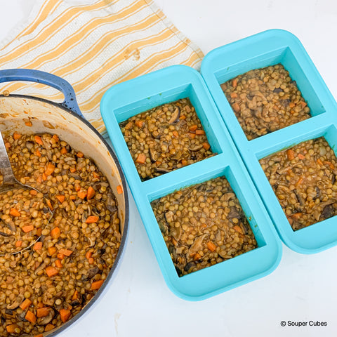 image of mushroom lentil base for shepherds pie in 2-cup souper cubes near a blue pot