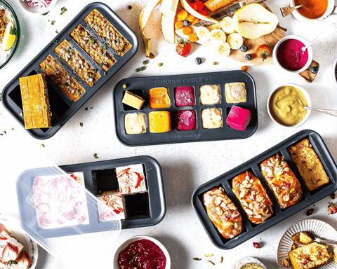 Four types of Souper Cubes® trays with various meals frozen in each tray. 
