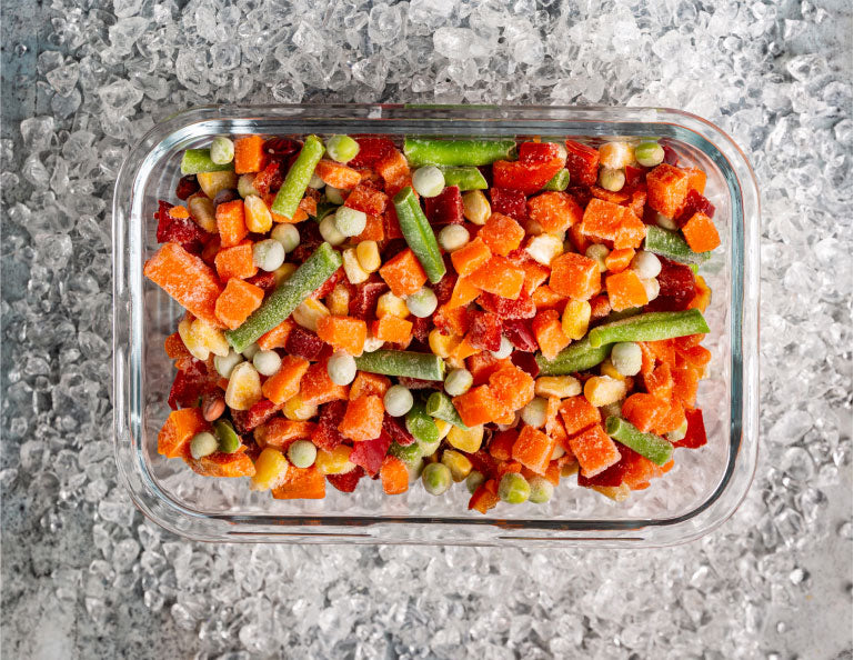 Frozen vegetables in a pyrex dish.