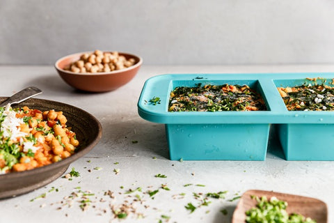 1-cup Souper Cubes trays with a frozen rice bowl and a cooked rice bowl in a brown bowl on the left hand side.