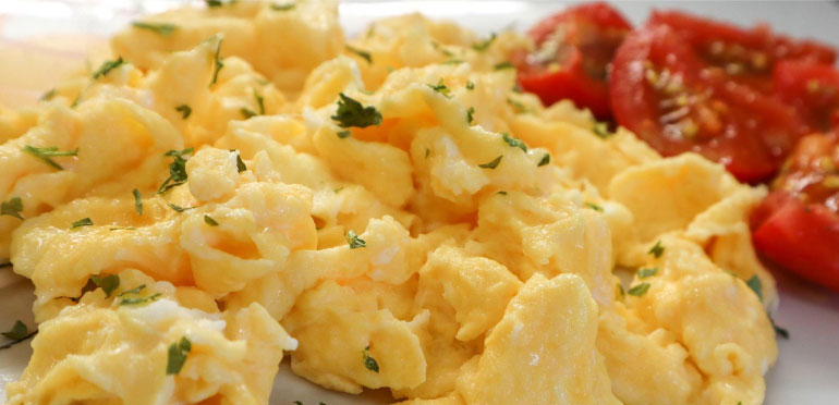 Scrambled eggs topped with herbs.