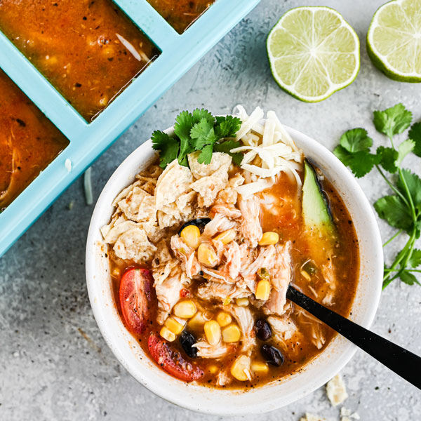 image of a bowl of chicken tortilla soup with garnishes