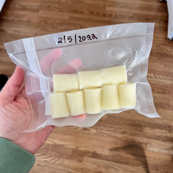 Frozen breast milk portions in a vacuum-sealed bag