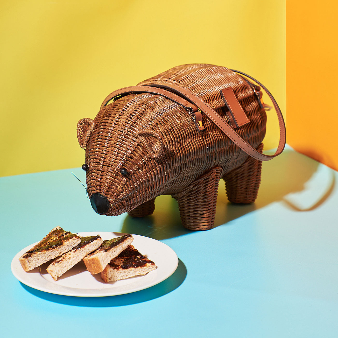Wicker Darling's Wally the Wombat bag on a colourful background