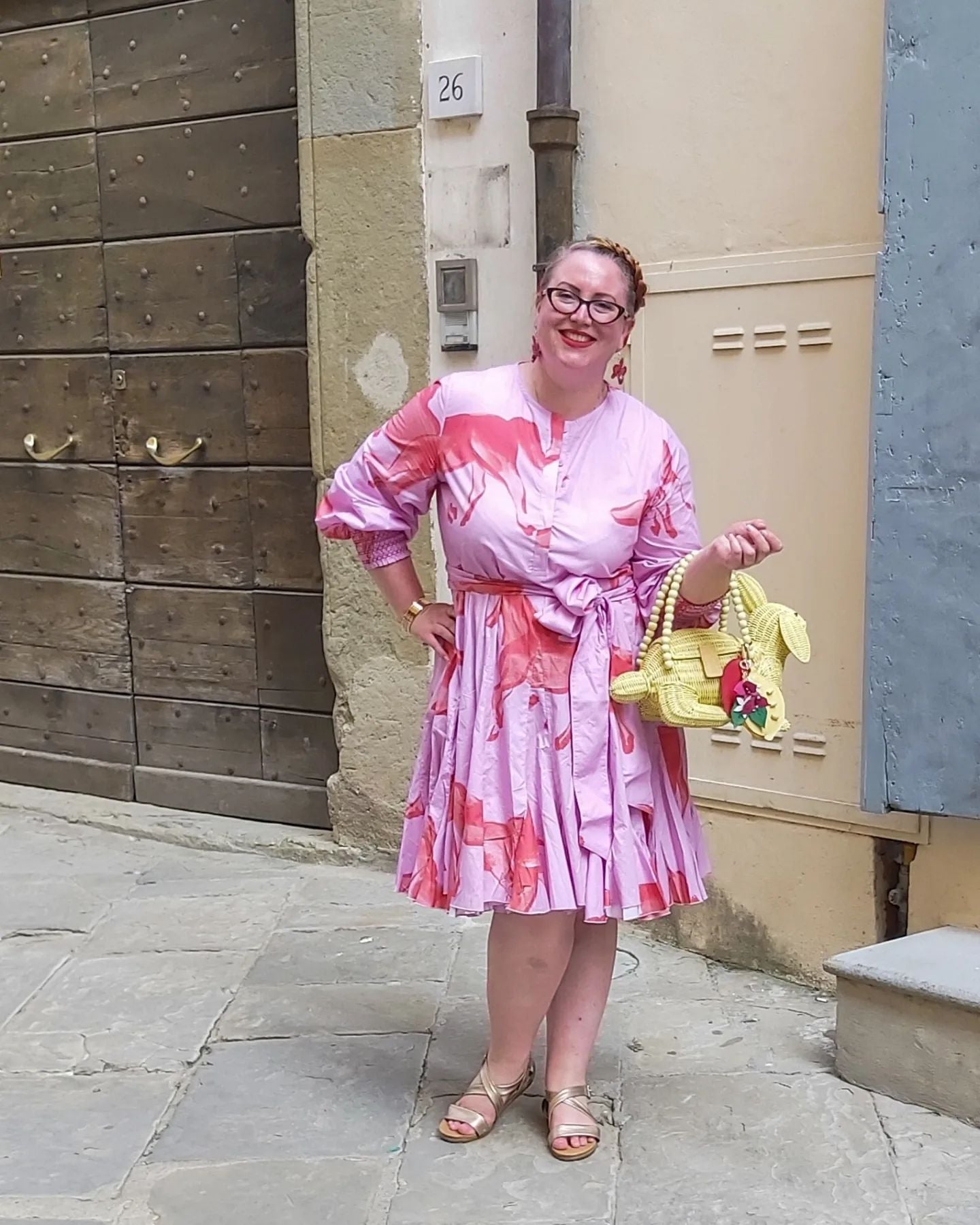 Jas, Wicker Darling CEO, is holding a yellow vegan bunny purse