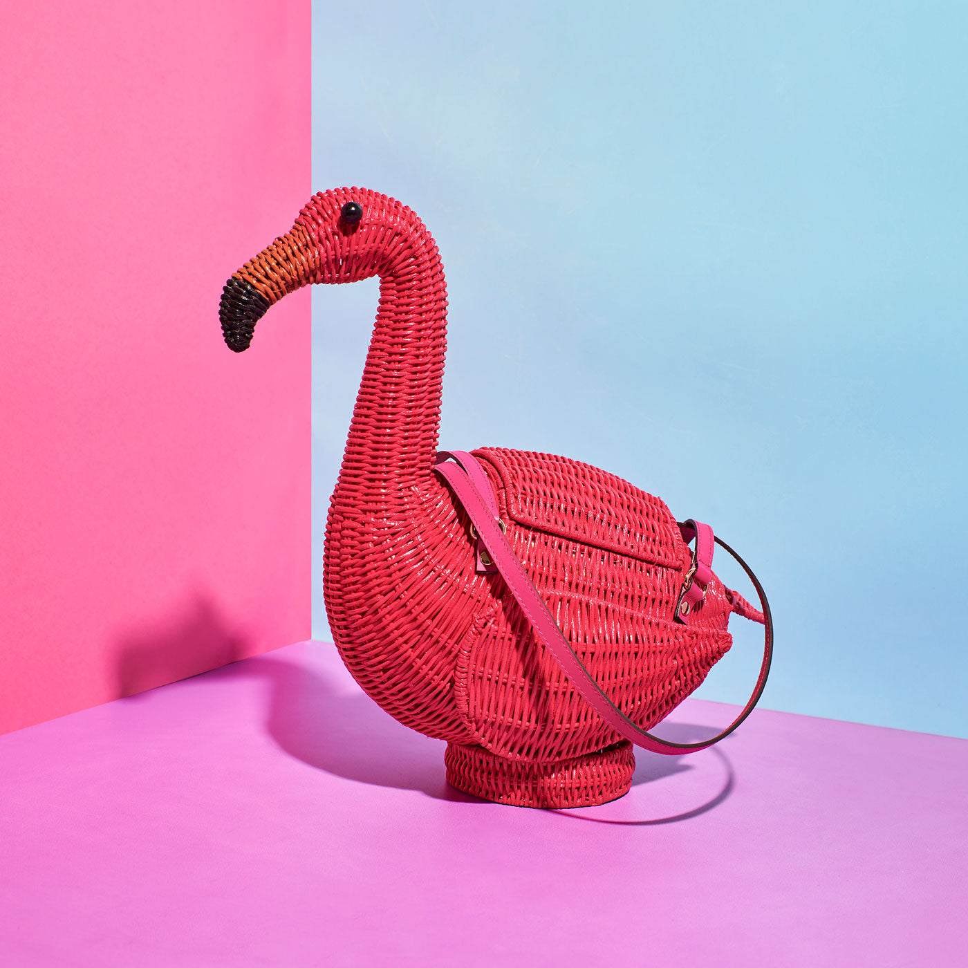 Wicker Darling's flamingo purse on a colourful background