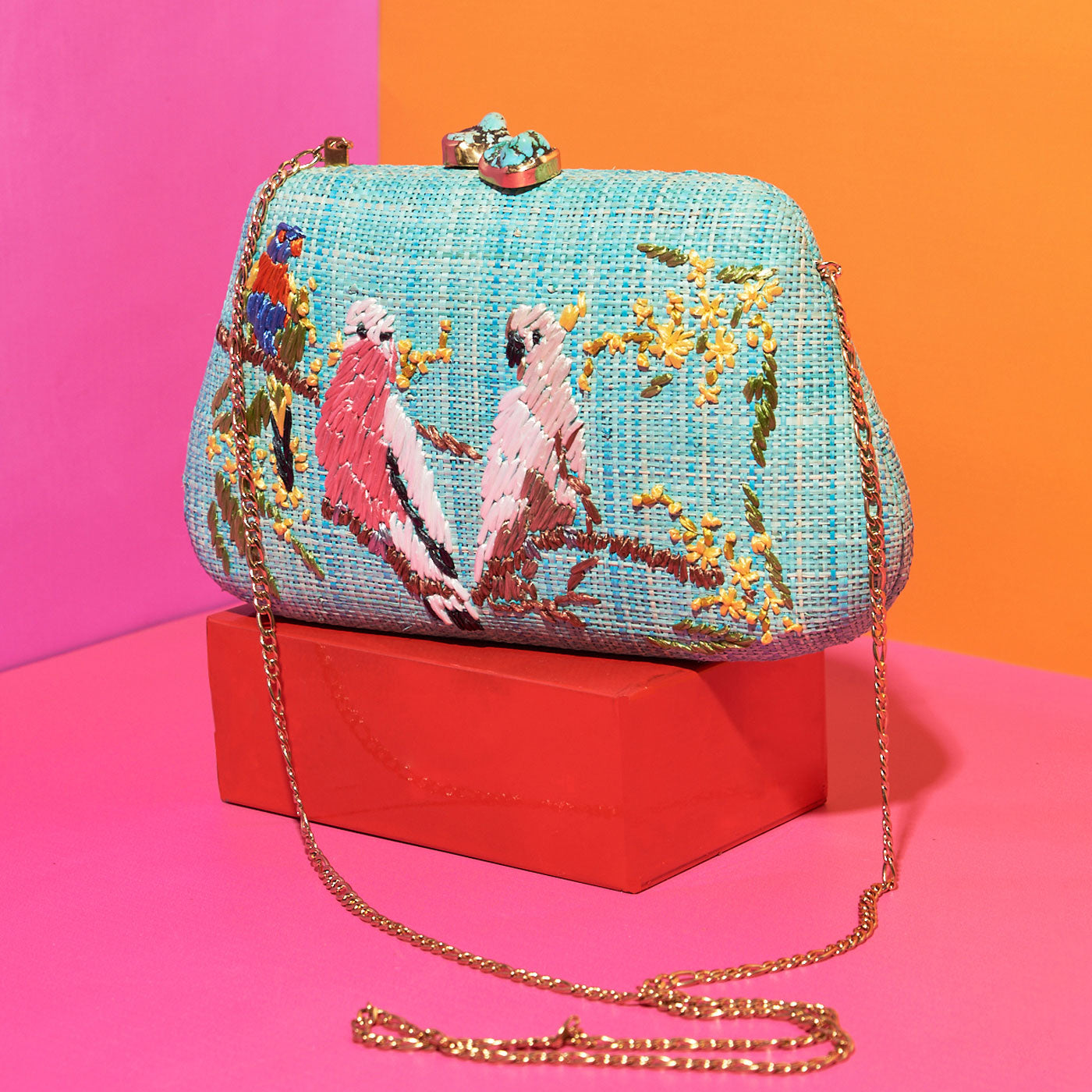 Wicker Darling's Australiana Clutch on a colourful background