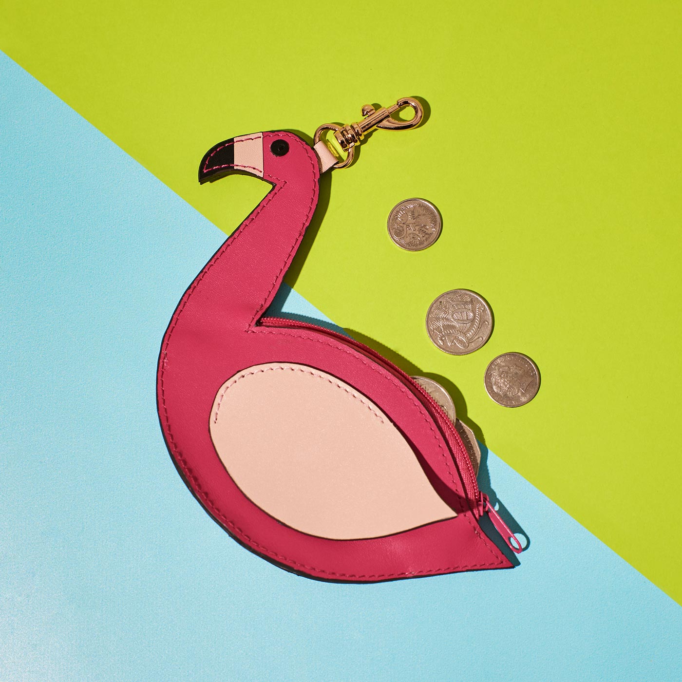 Wicker Darling's flamingo coin purse on a colourful background