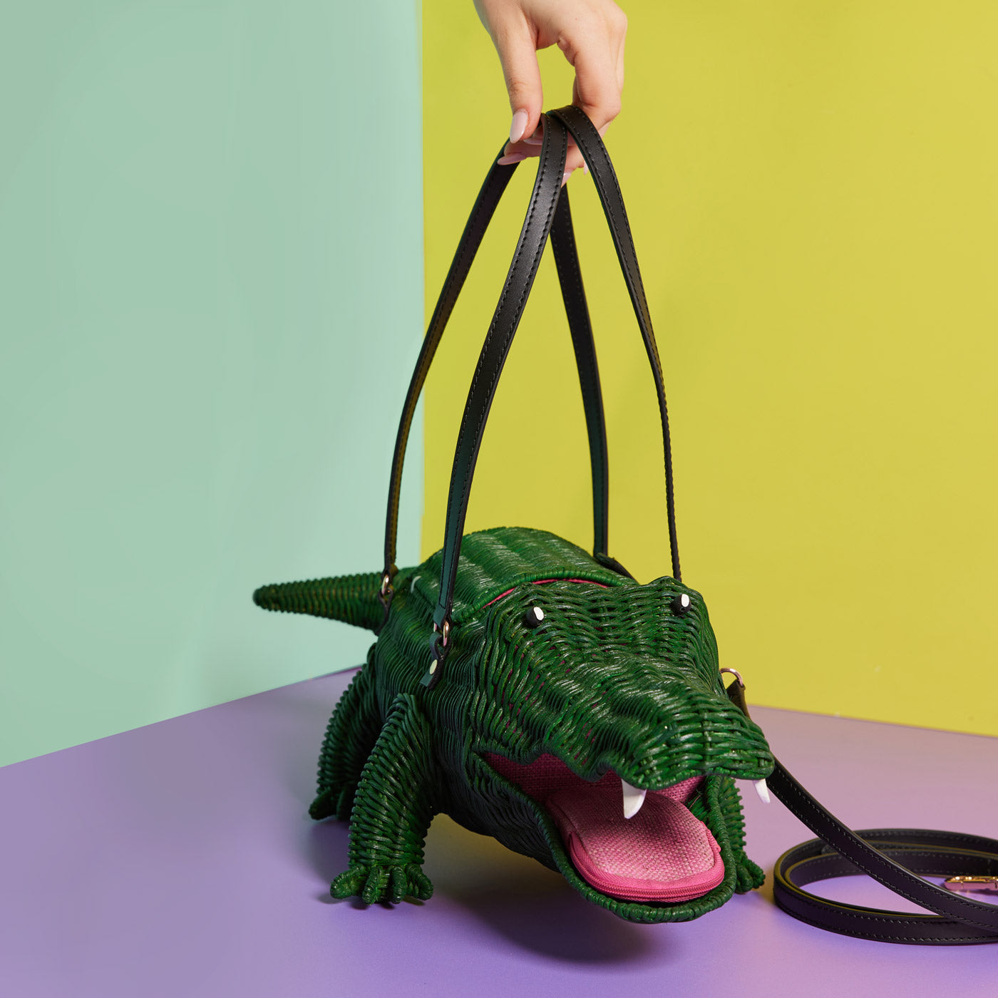 Hand holding a Wicker Darling Crocogator the Crocodile Bag