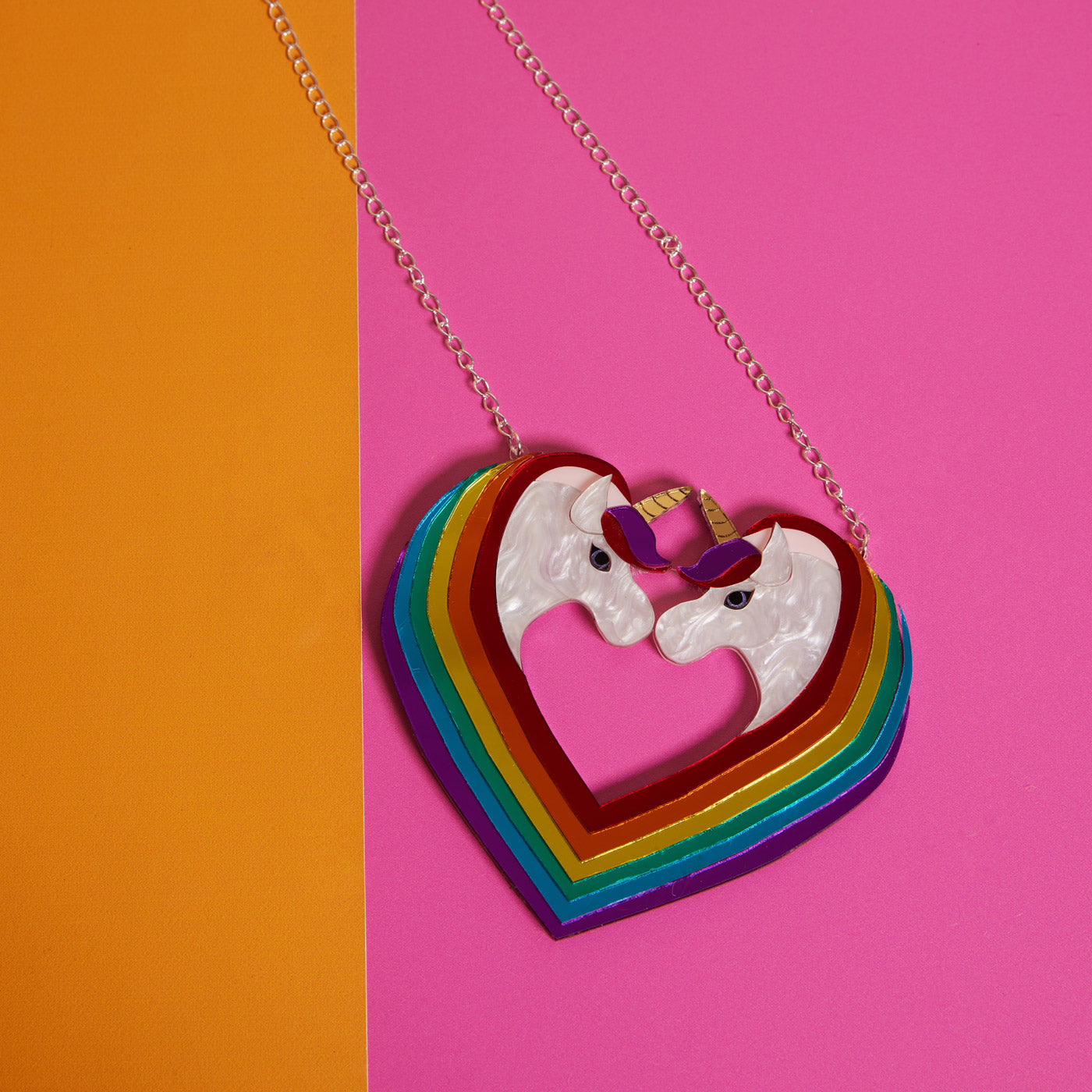 Wicker Darling's Vienna the rainbow unicorn necklace on a colourful background